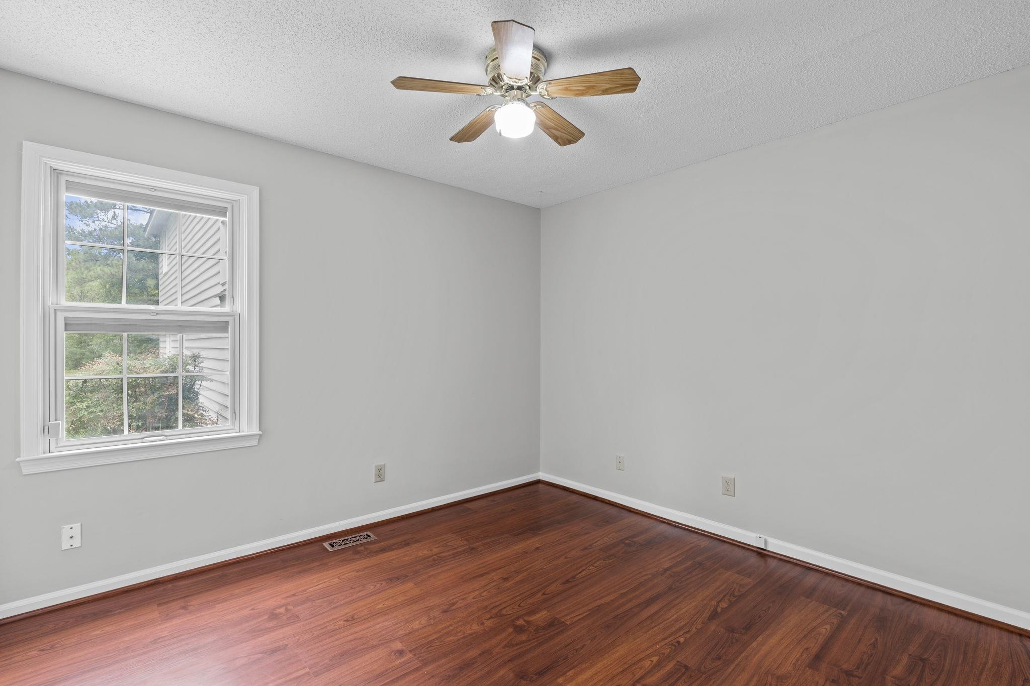 119 Lakeside Circle Willow Spring, NC 27592 - Photo 18 of 37 wooden floor in an empty room with a window