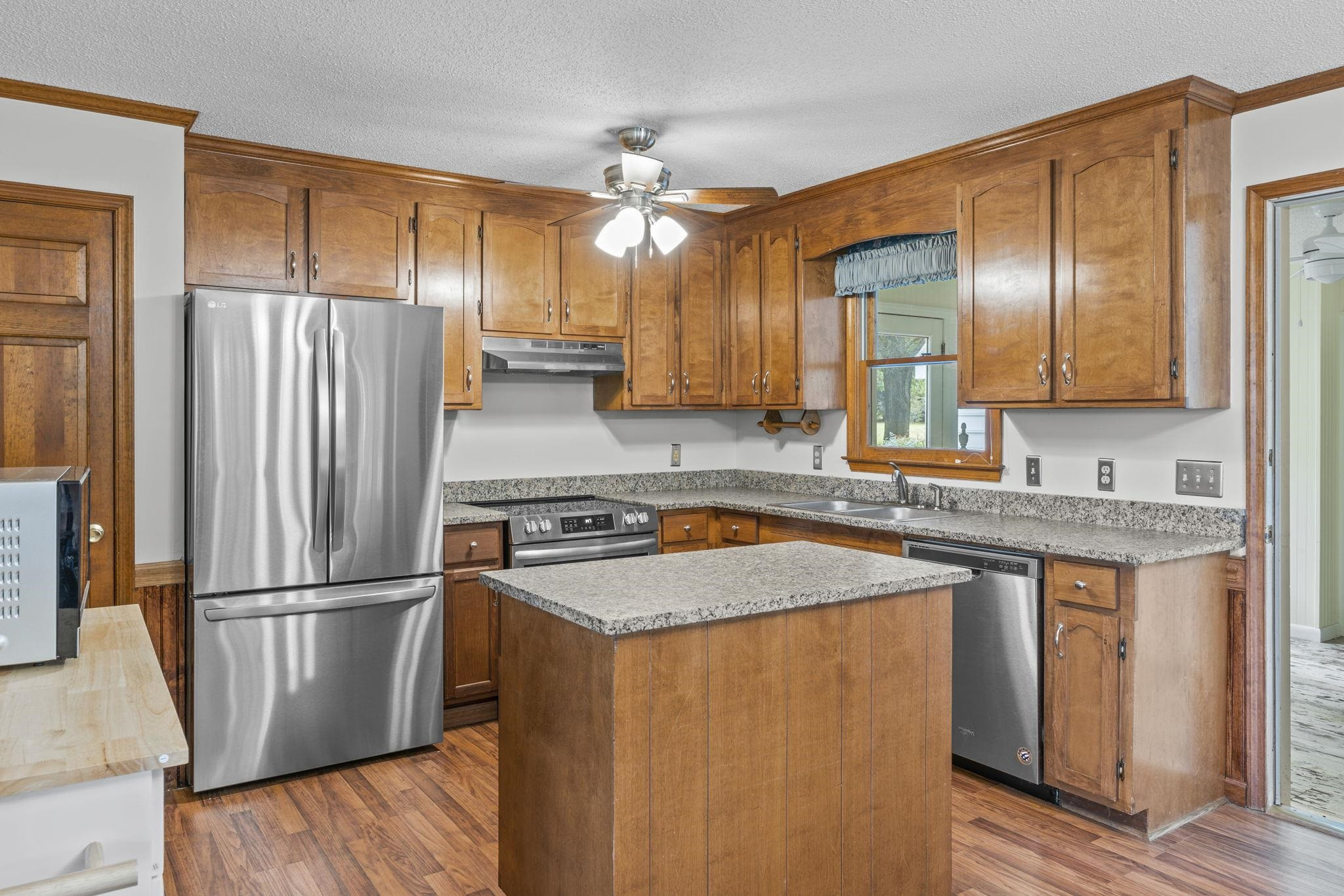 119 Lakeside Circle Willow Spring, NC 27592 - Photo 2 of 37 a kitchen with stainless steel appliances granite countertop a refrigerator a sink dishwasher a stove with wooden floor and cabinets