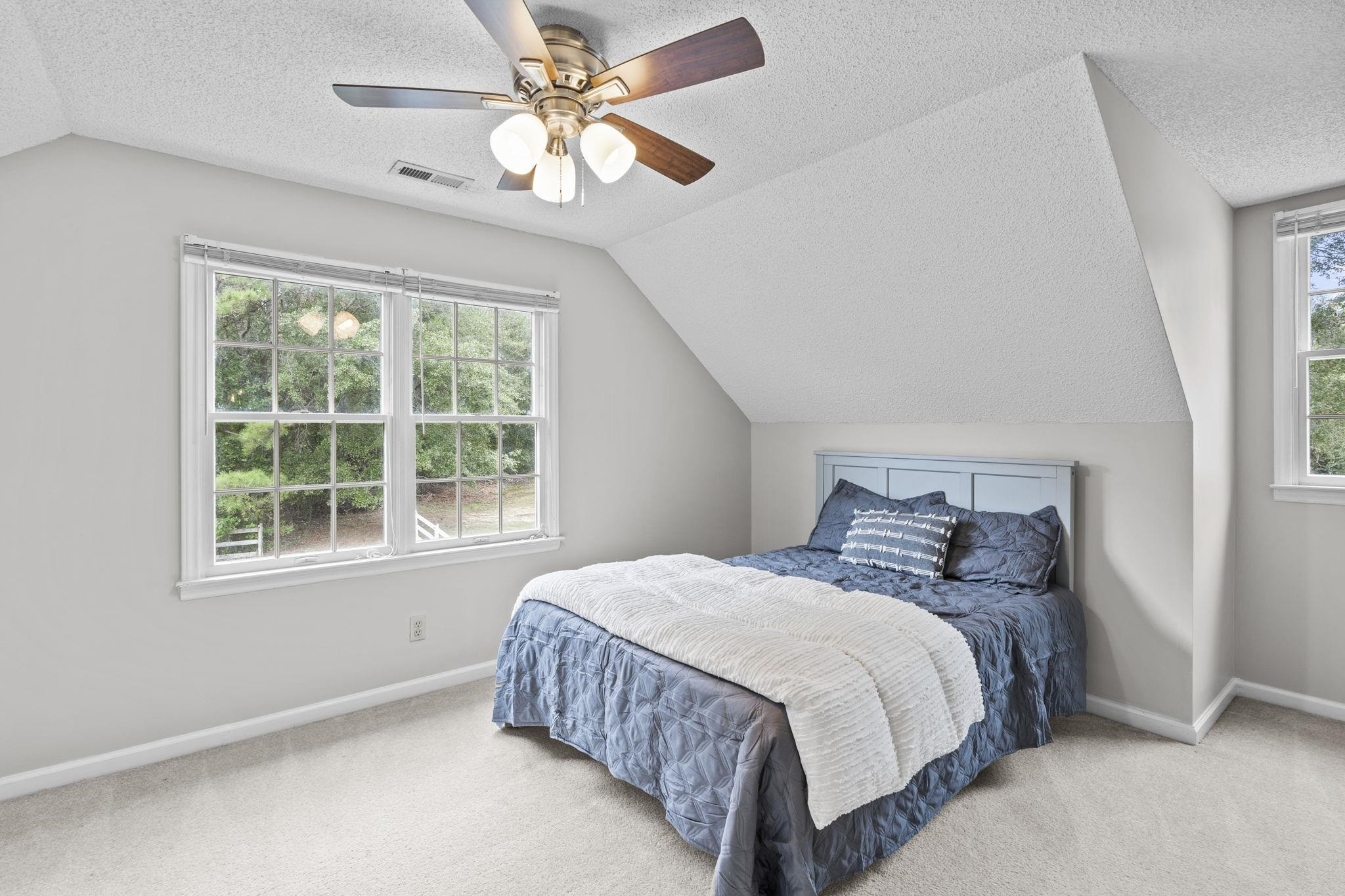 119 Lakeside Circle Willow Spring, NC 27592 - Photo 23 of 37 a bedroom with a bed chandelier and a window