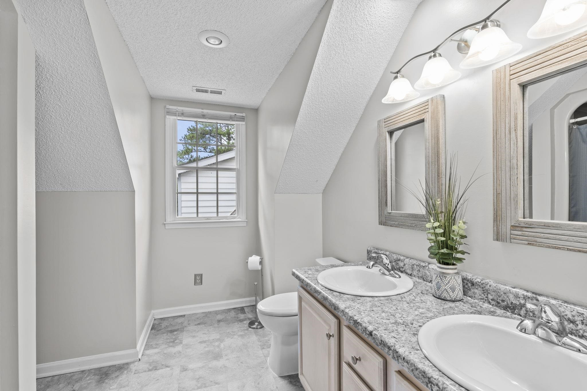 119 Lakeside Circle Willow Spring, NC 27592 - Photo 25 of 37 a bathroom with a granite countertop sink a toilet and a mirror