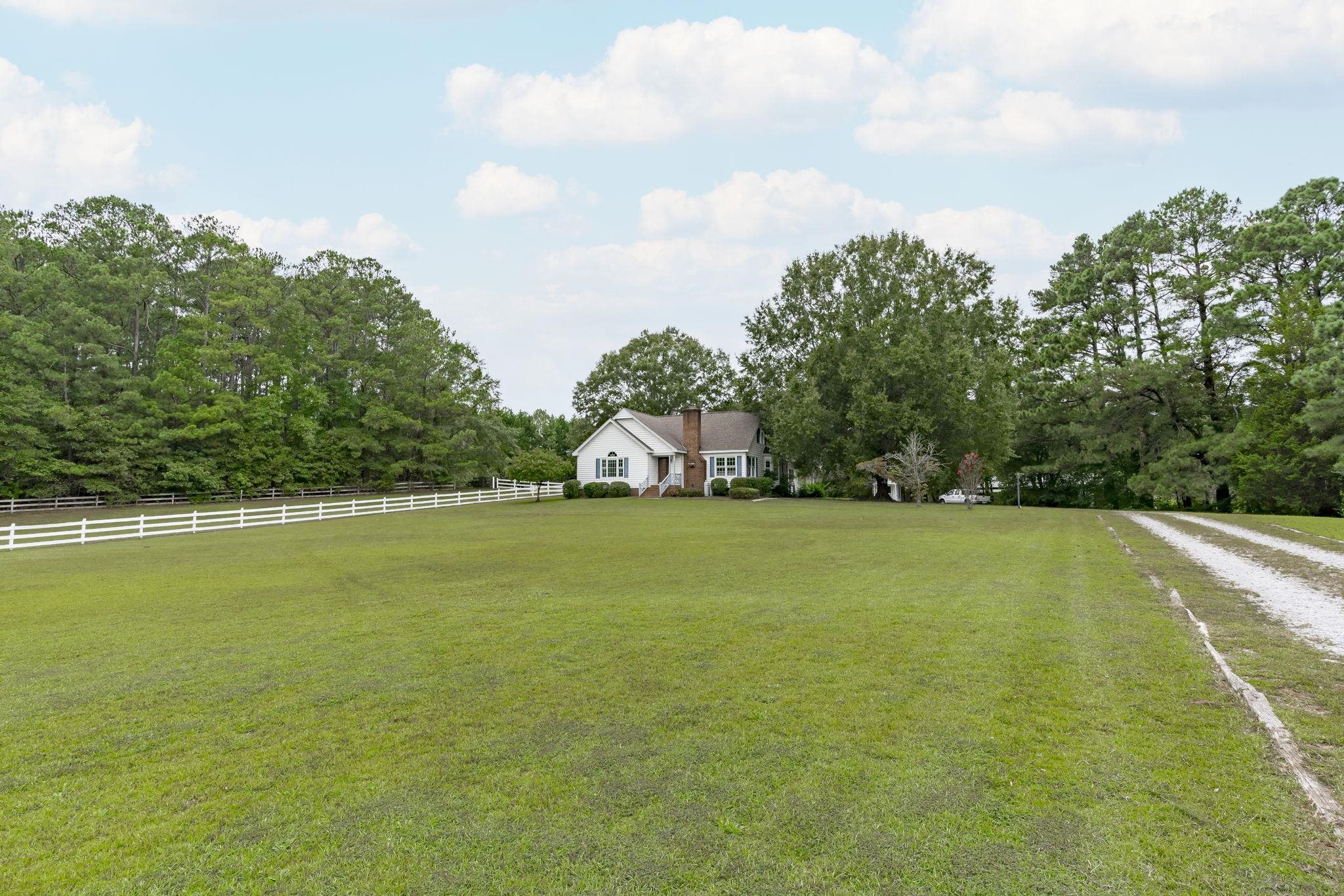 119 Lakeside Circle Willow Spring, NC 27592 - Photo 33 of 37 a view of a swimming pool and trees in the background