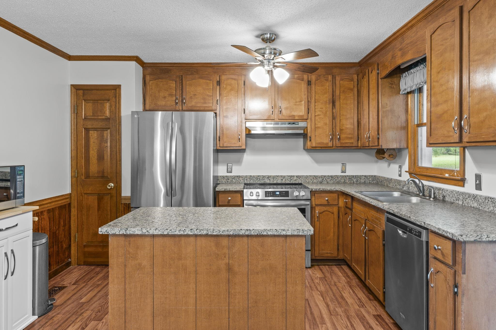 119 Lakeside Circle Willow Spring, NC 27592 - Photo 6 of 37 a kitchen with stainless steel appliances granite countertop a sink a stove and a refrigerator