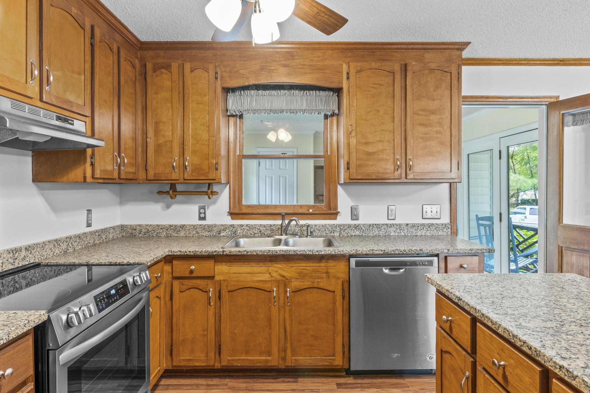 119 Lakeside Circle Willow Spring, NC 27592 - Photo 7 of 37 a kitchen with granite countertop a sink a stove and cabinets