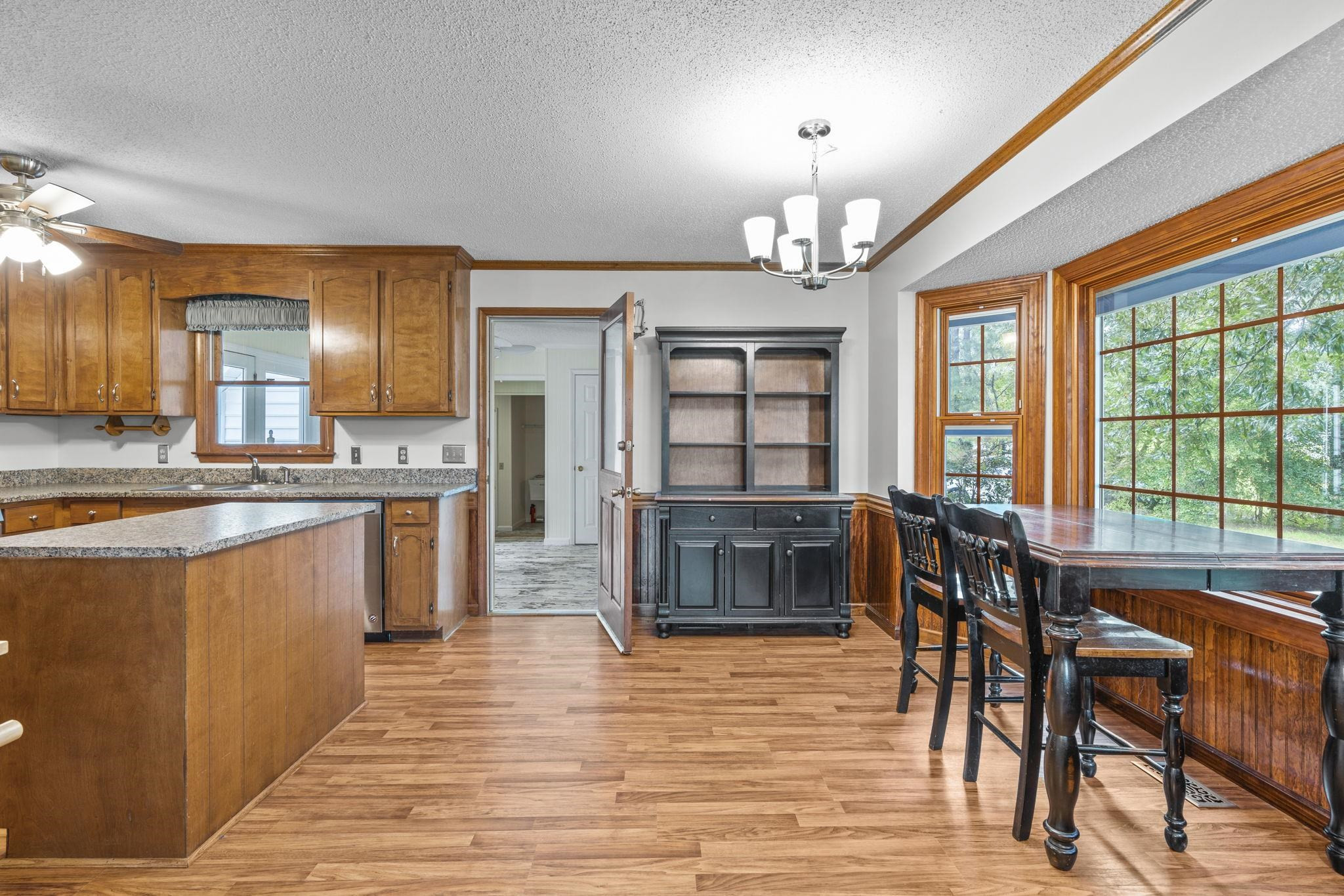 119 Lakeside Circle Willow Spring, NC 27592 - Photo 9 of 37 a kitchen with stainless steel appliances granite countertop a stove top oven a sink dishwasher and a dining table with wooden floor