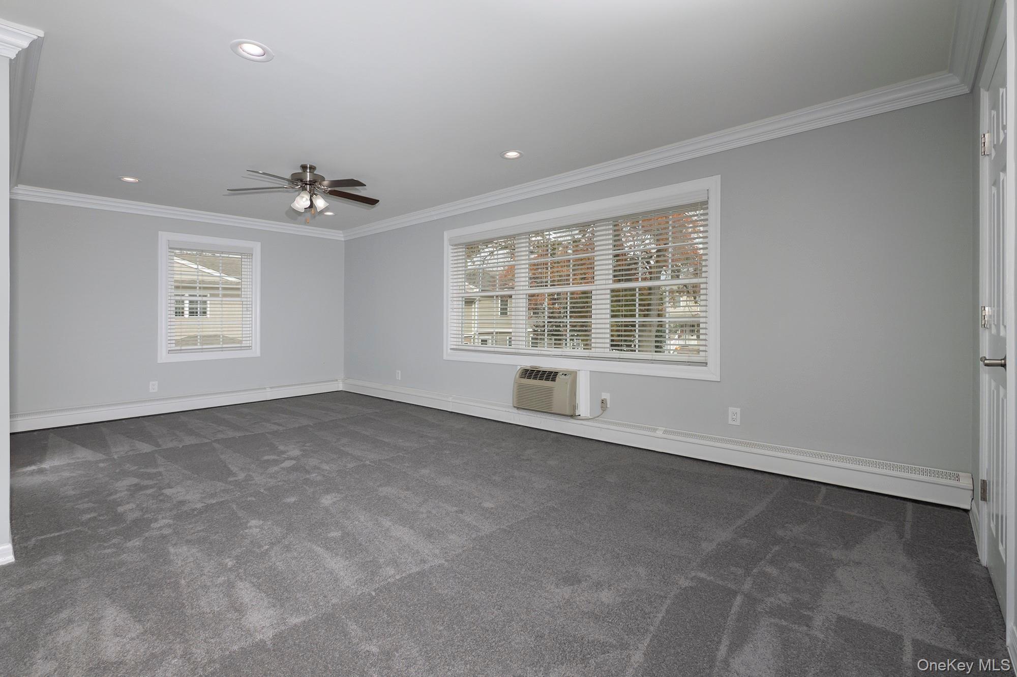 55 Fairfield Way, Unit HE03 Commack, NY 11725 - Photo 3 of 9 a view of an empty room with a window