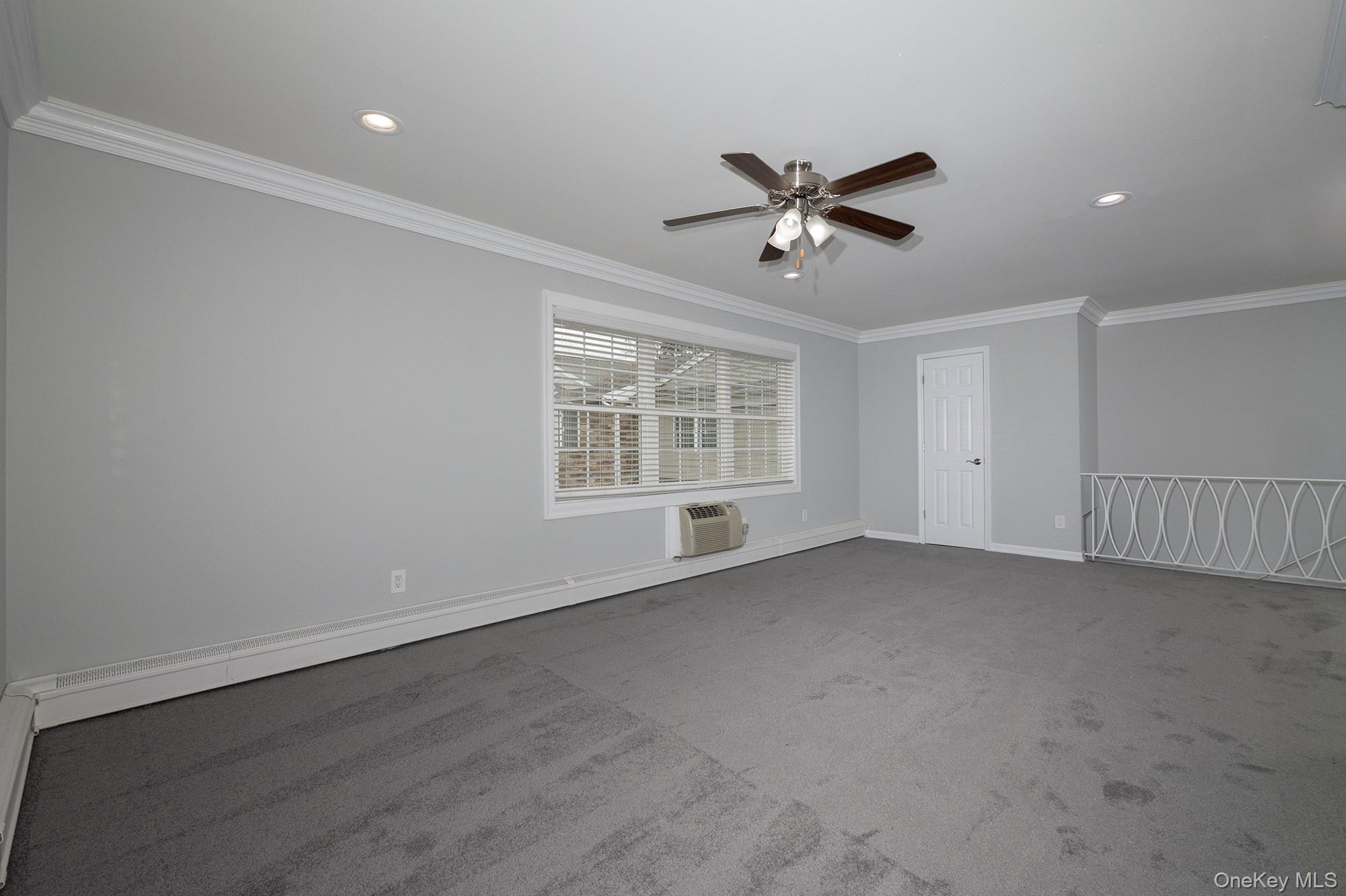 55 Fairfield Way, Unit HE03 Commack, NY 11725 - Photo 4 of 9 a view of an empty room with a window