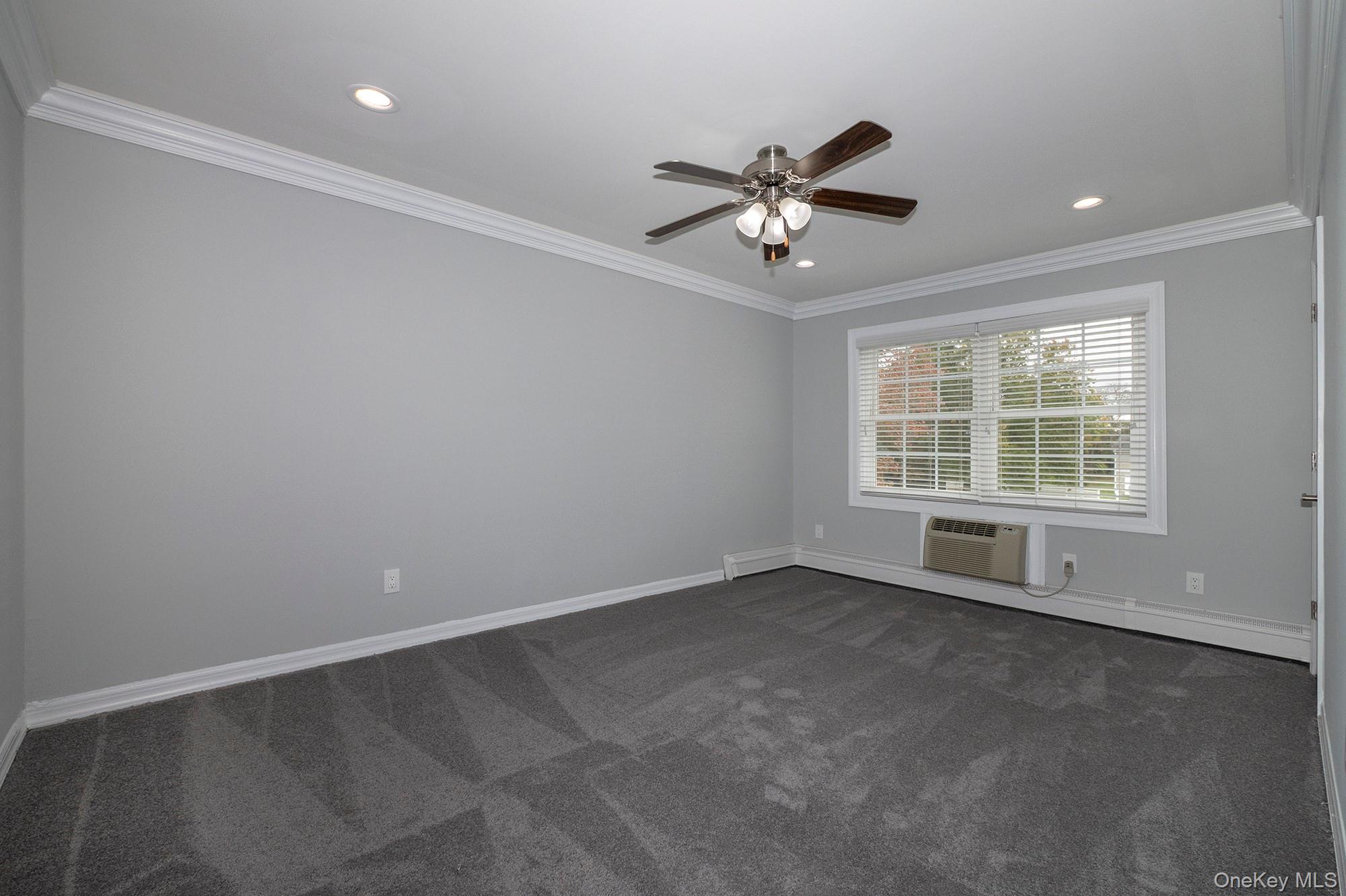 55 Fairfield Way, Unit HE03 Commack, NY 11725 - Photo 5 of 9 a view of an empty room with a window