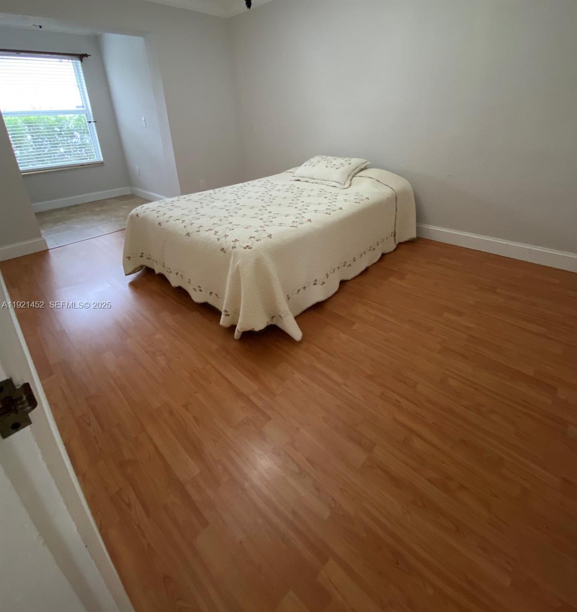 7880 Southwest 14th Terrace Miami, FL 33144 - Photo 12 of 43 a bedroom with a bed and a window