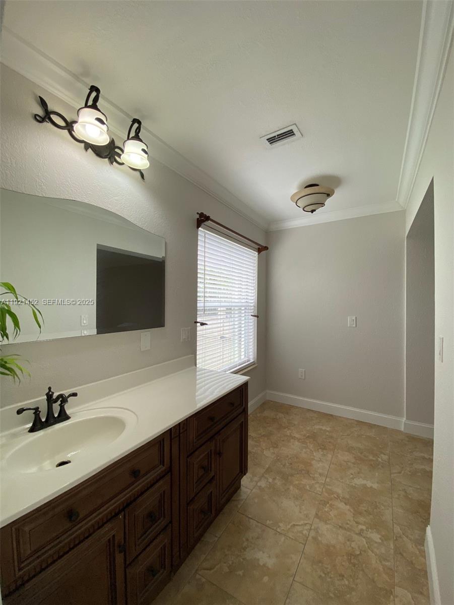7880 Southwest 14th Terrace Miami, FL 33144 - Photo 16 of 43 a spacious bathroom with a double vanity sink and a mirror