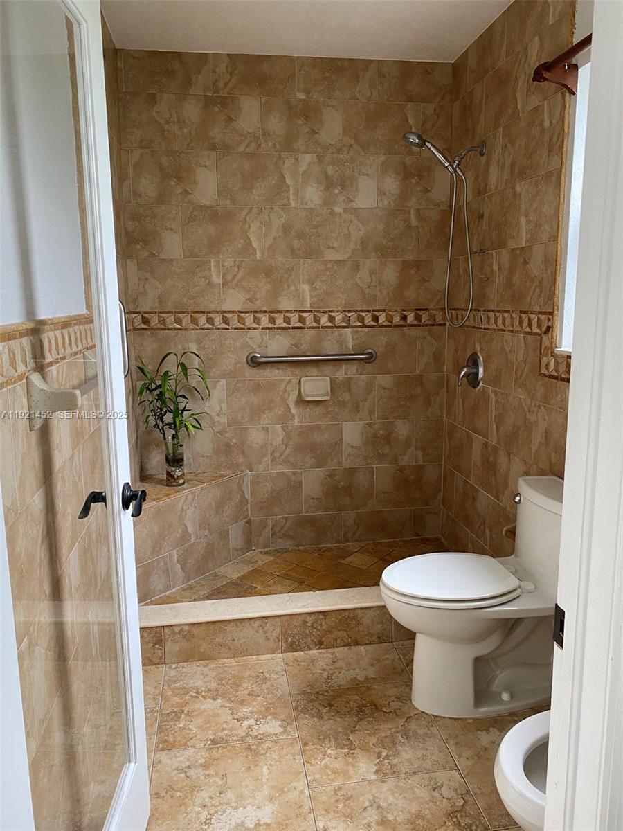 7880 Southwest 14th Terrace Miami, FL 33144 - Photo 18 of 43 a bathroom with a toilet and a shower