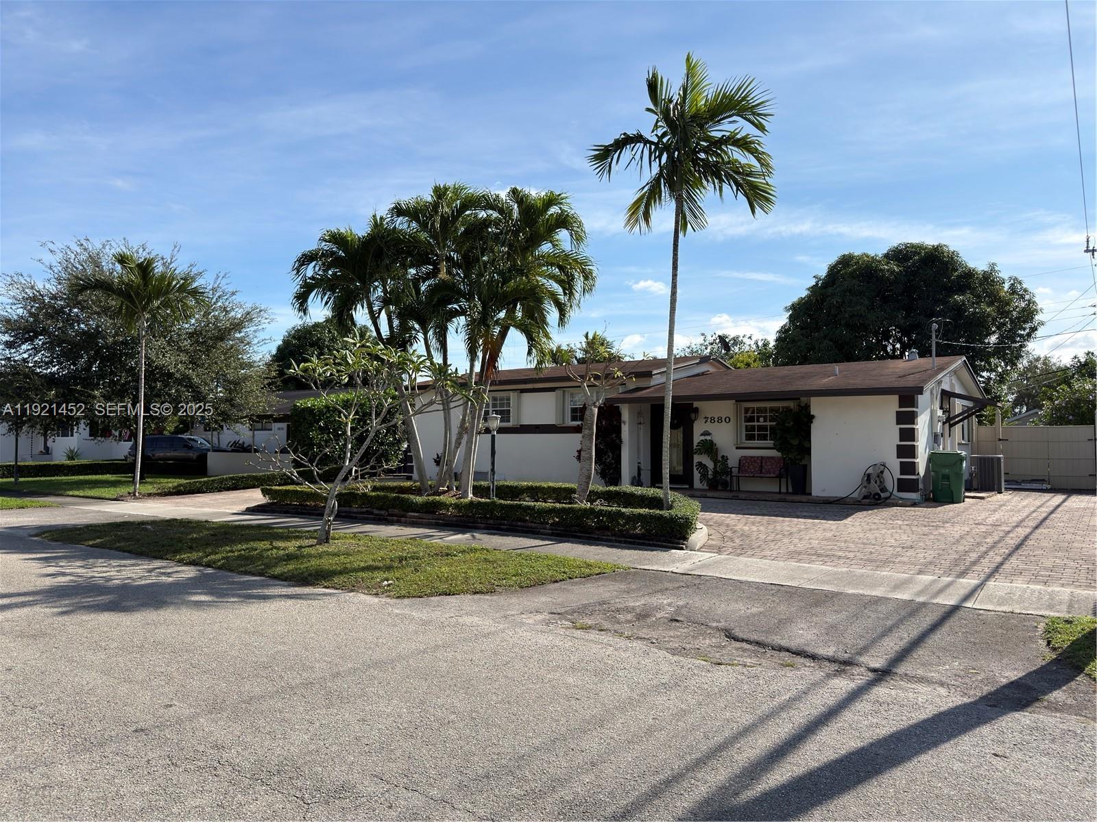 7880 Southwest 14th Terrace Miami, FL 33144 - Photo 2 of 43 a palm tree sitting in front of a house with a yard