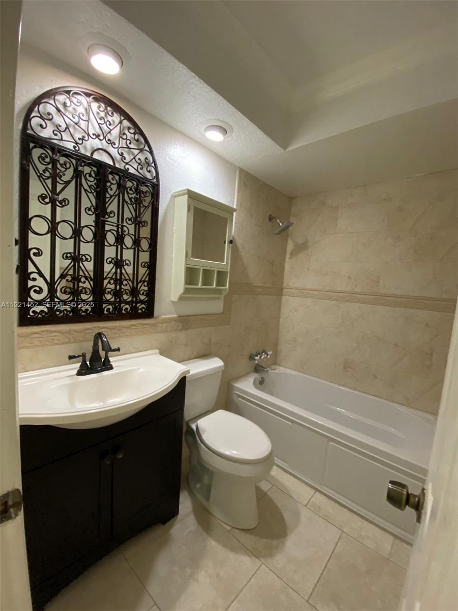 7880 Southwest 14th Terrace Miami, FL 33144 - Photo 24 of 43 a bathroom with a double vanity sink mirror and toilet