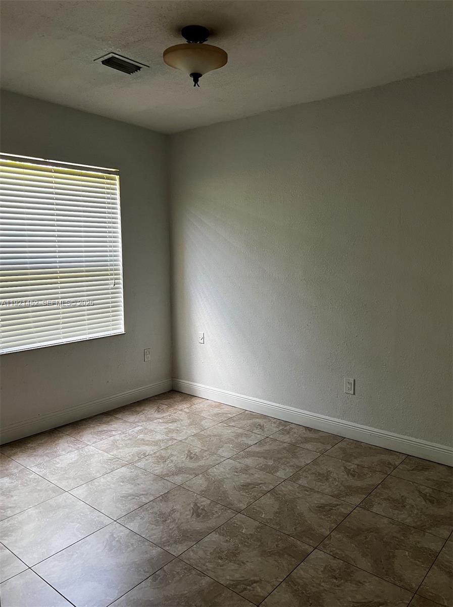 7880 Southwest 14th Terrace Miami, FL 33144 - Photo 32 of 43 an empty room with a empty space and windows
