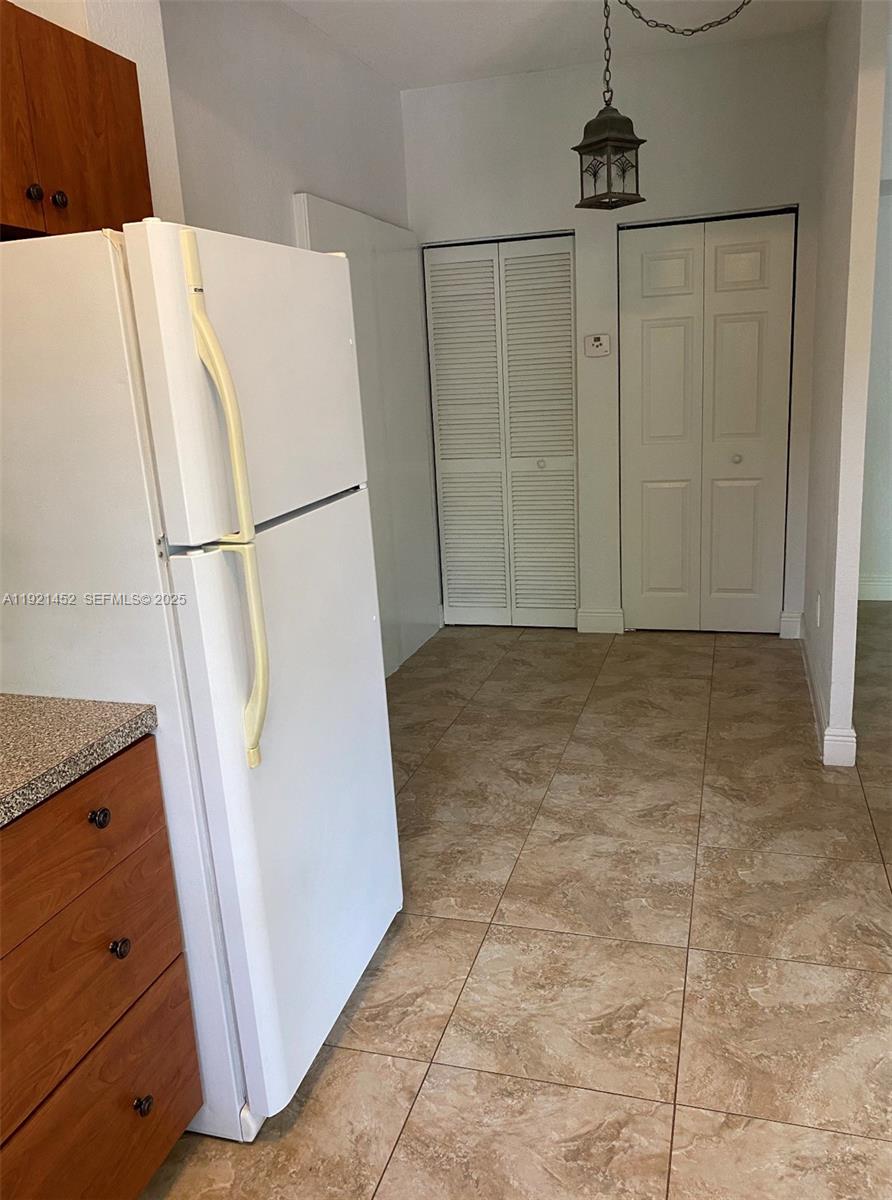 7880 Southwest 14th Terrace Miami, FL 33144 - Photo 36 of 43 a white refrigerator freezer sitting in a kitchen