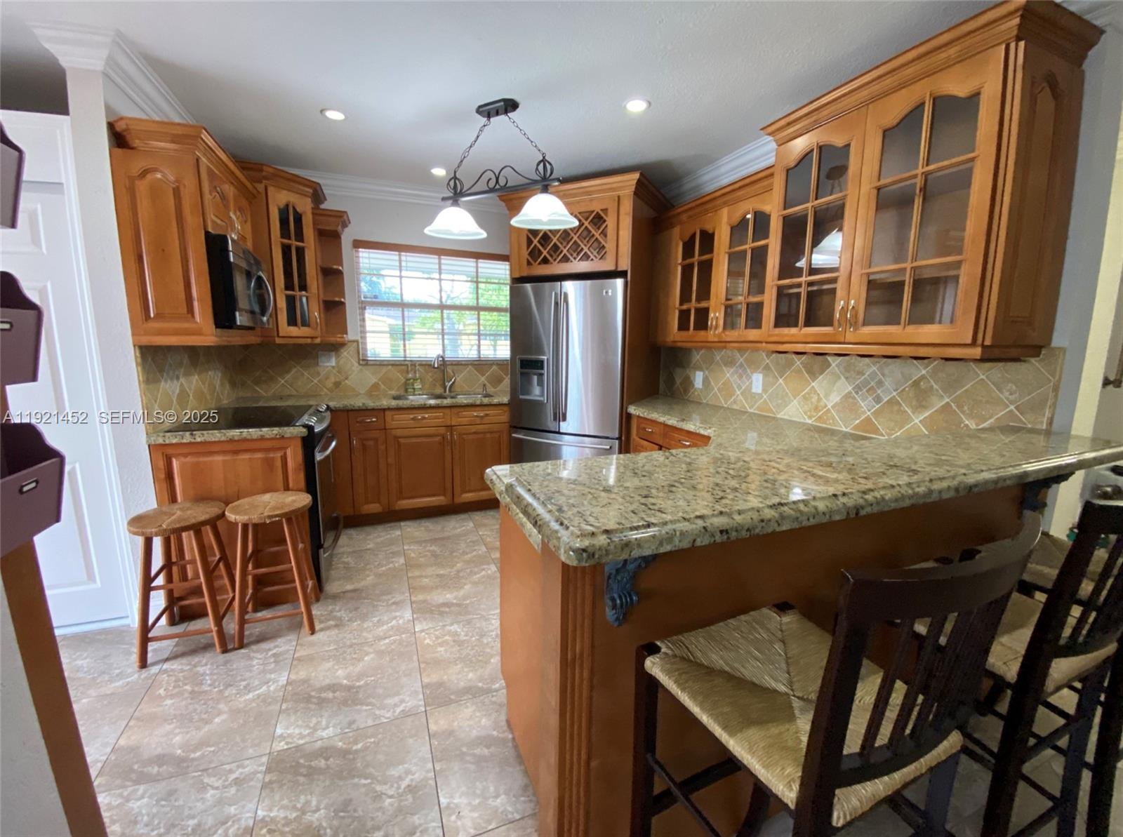 7880 Southwest 14th Terrace Miami, FL 33144 - Photo 5 of 43 a kitchen with a table and chairs in it