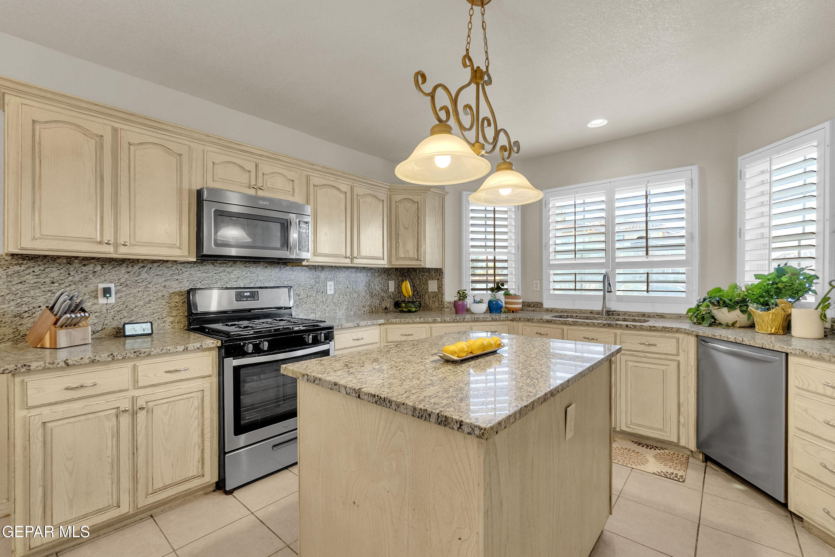6531 Brook Ridge Circle El Paso, TX 79912 - Photo 22 of 73 a kitchen with stainless steel appliances granite countertop a sink a stove a window cabinets and a counter top space