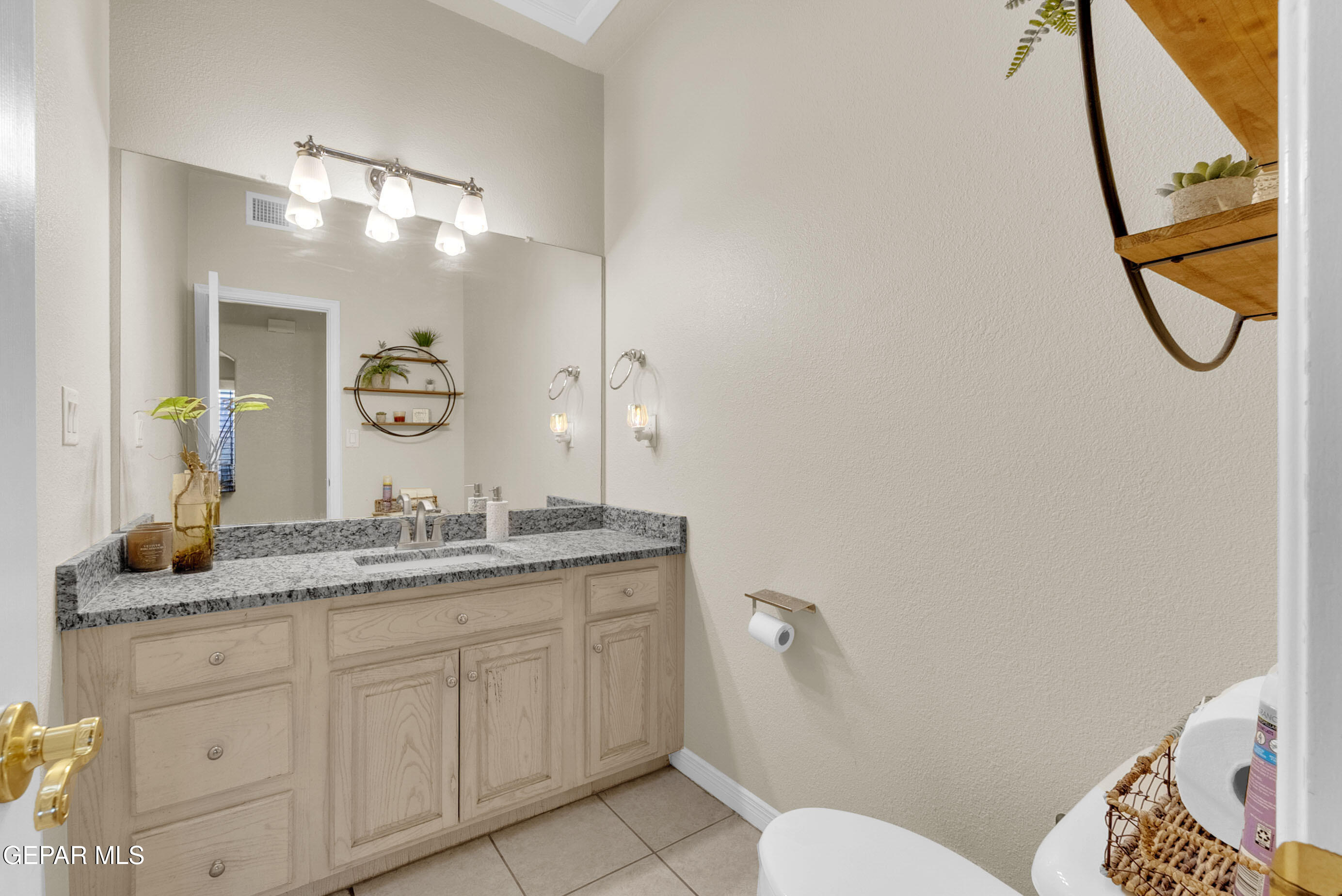 6531 Brook Ridge Circle El Paso, TX 79912 - Photo 30 of 73 a bathroom with a granite countertop sink mirror and vanity