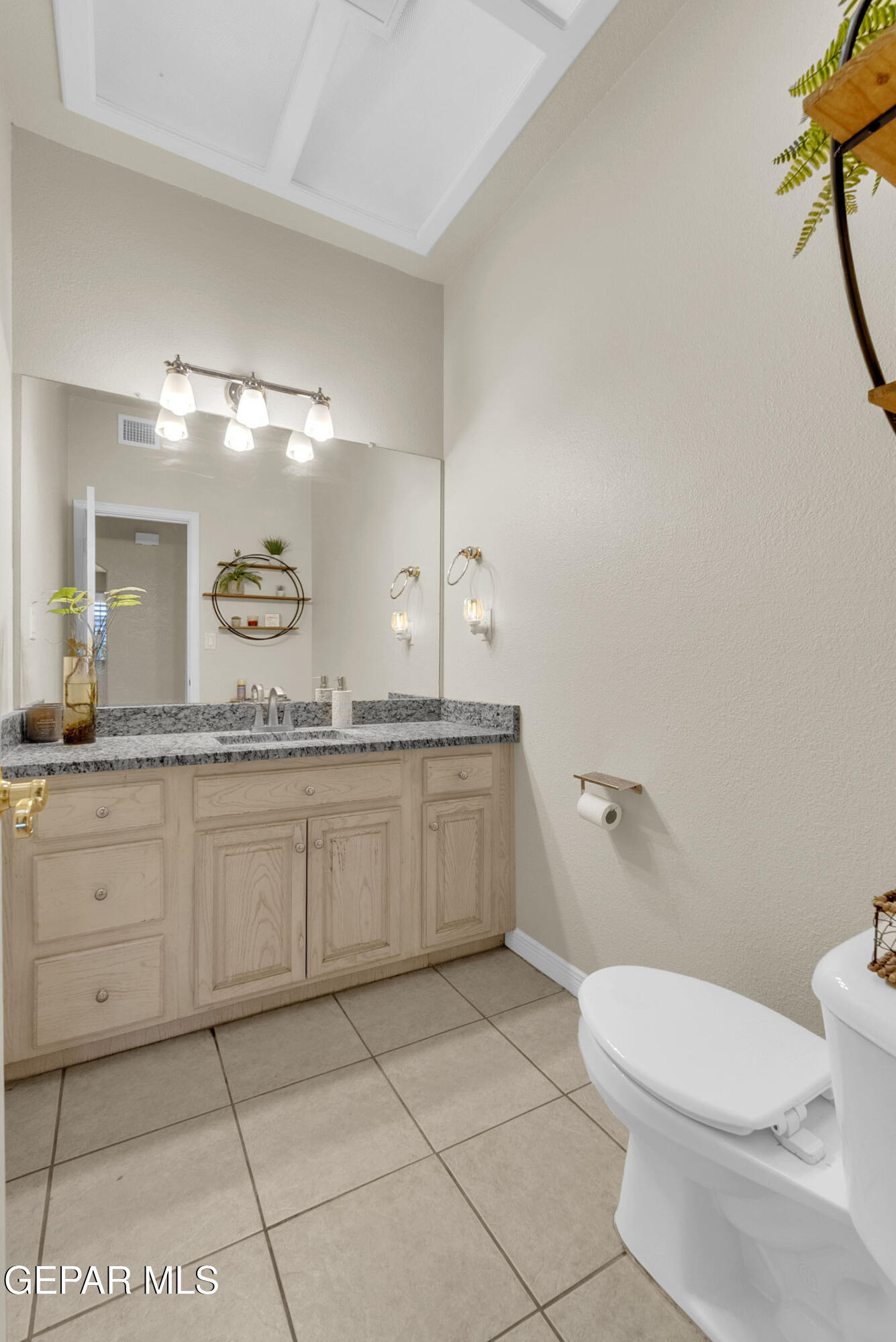 6531 Brook Ridge Circle El Paso, TX 79912 - Photo 31 of 73 a bathroom with a granite countertop toilet sink and mirror