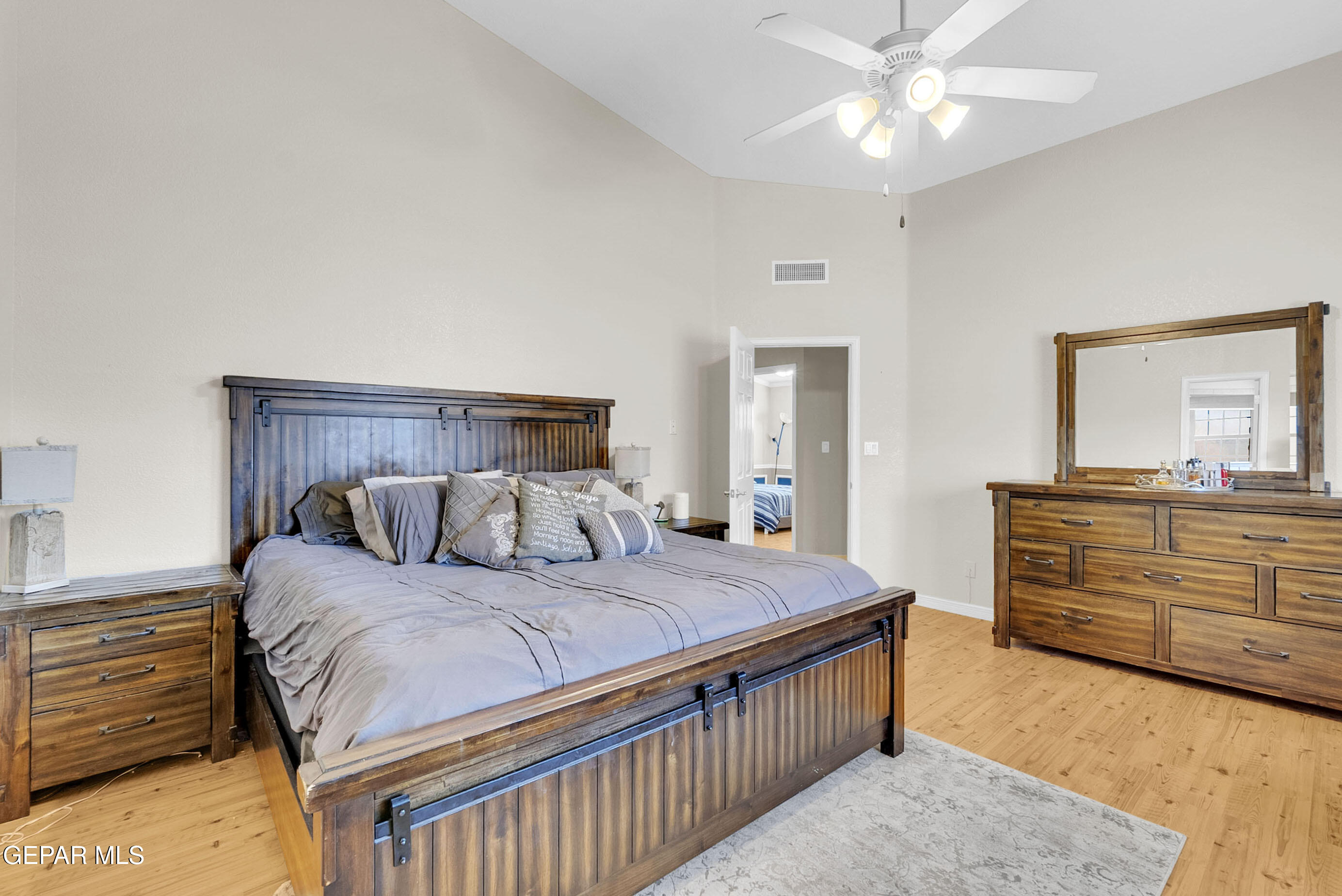 6531 Brook Ridge Circle El Paso, TX 79912 - Photo 33 of 73 a bedroom with a large bed and a chandelier