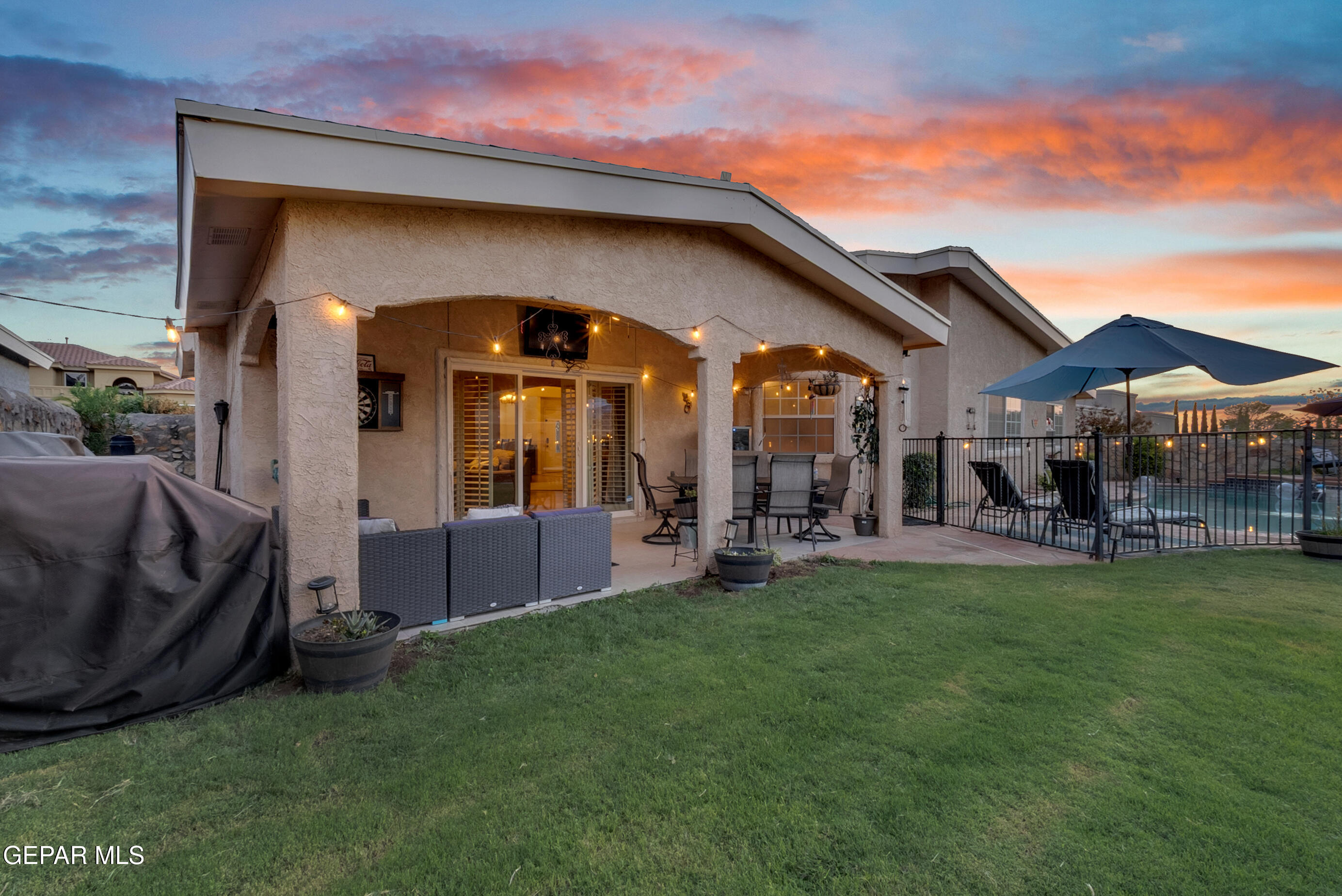 6531 Brook Ridge Circle El Paso, TX 79912 - Photo 55 of 73 a view of a house with a swimming pool and a yard