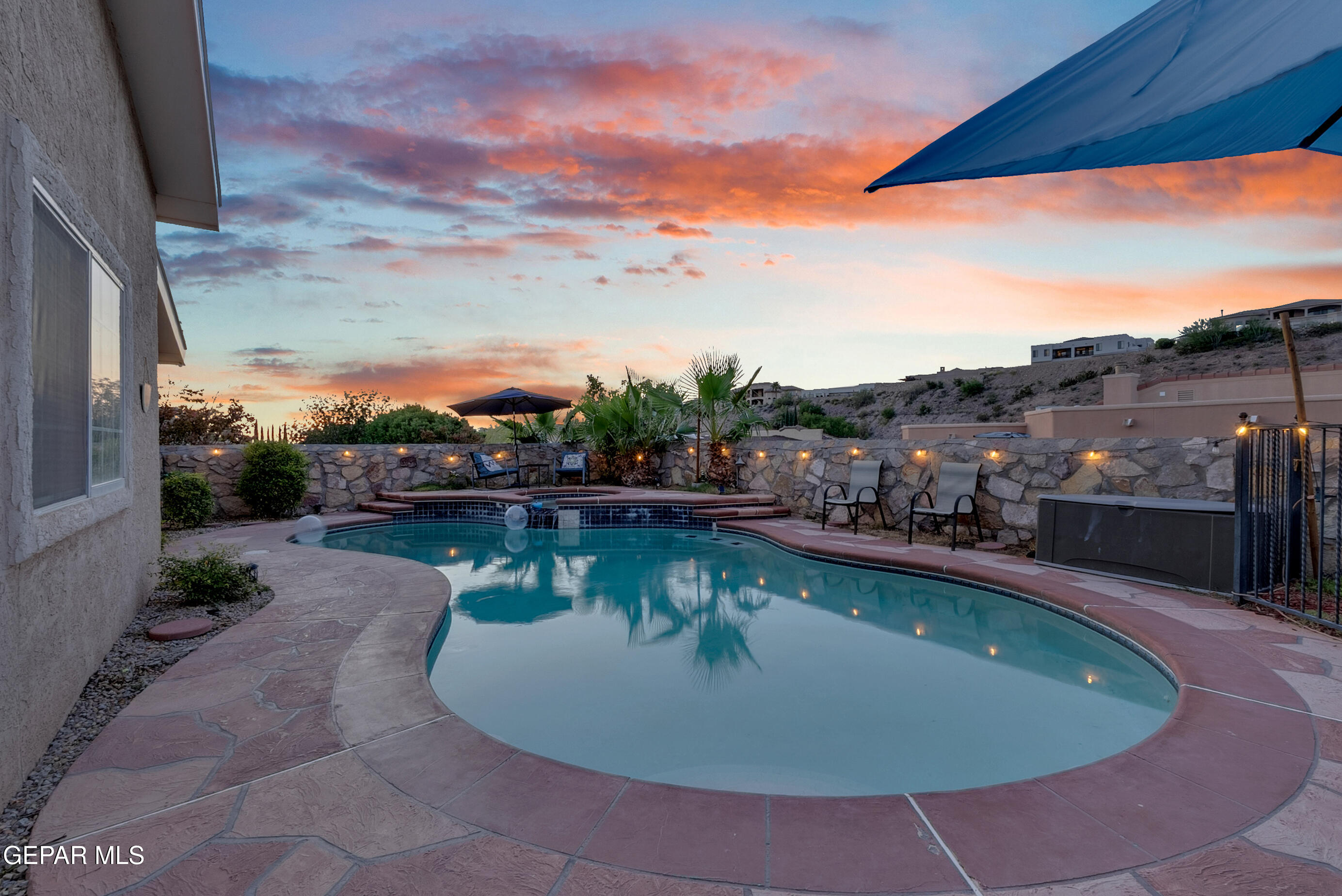 6531 Brook Ridge Circle El Paso, TX 79912 - Photo 61 of 73 a view of a swimming pool with a lounge chair