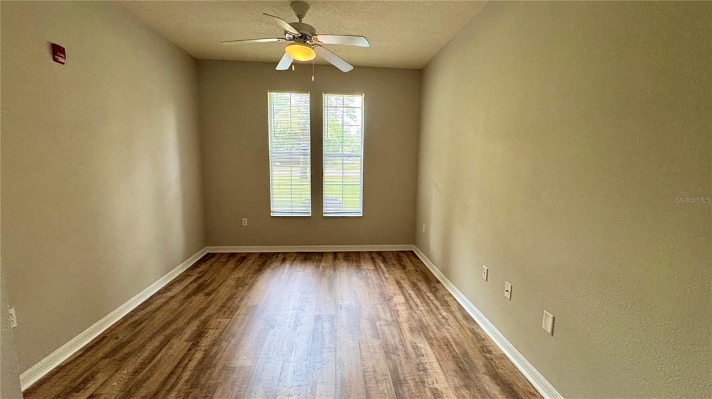 3443 Southwest 24th Street, Unit 101 Gainesville, FL 32608 - Photo 11 of 16 wooden floor in an empty room with a window