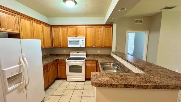 a kitchen with a refrigerator sink and stove