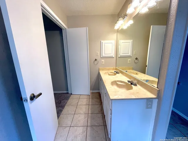 a bathroom with a sink a toilet and mirror