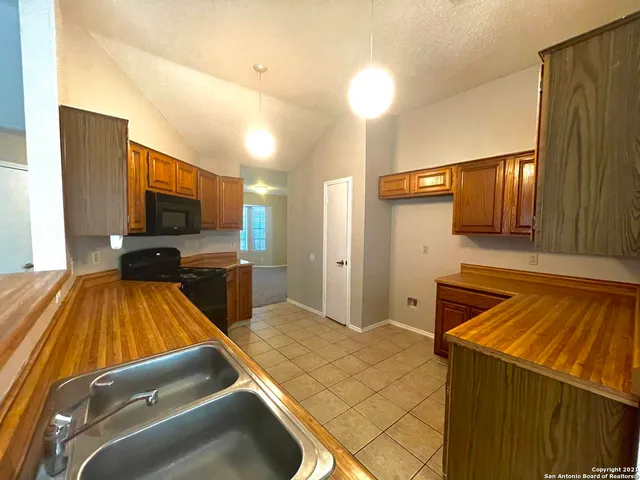 a room with pool table and flat screen tv