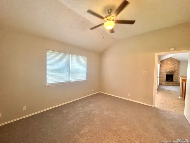 an empty room with a empty space and a ceiling fan