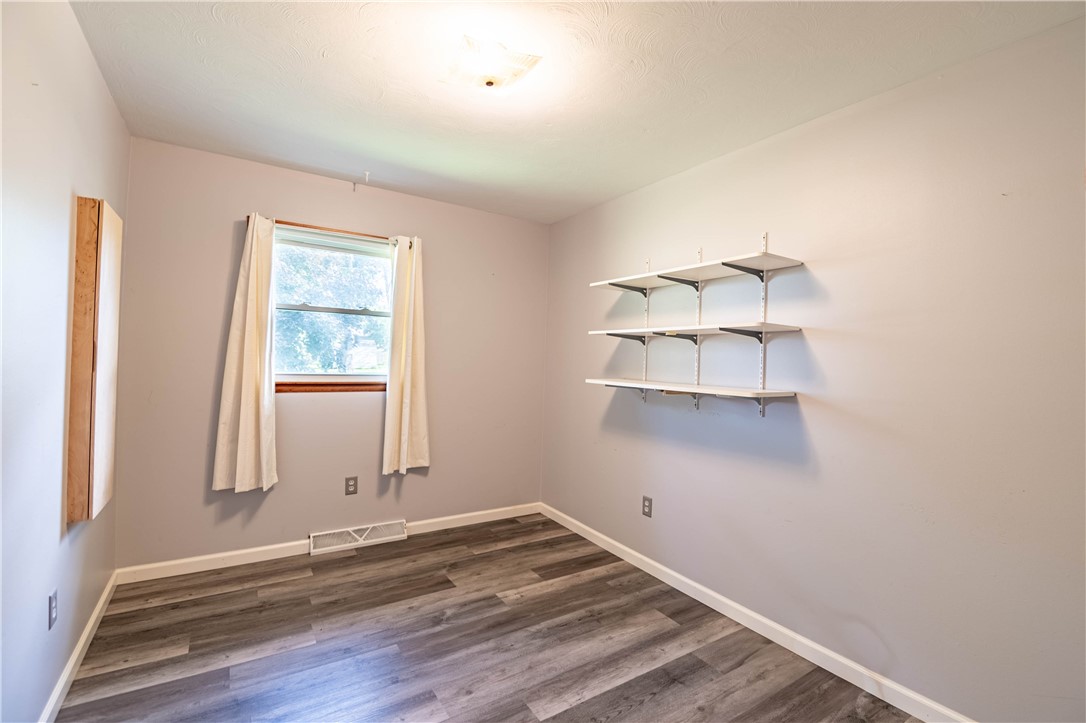 1823 Cooper Drive Decatur, IL 62526 - Photo 16 of 21 an empty room with wooden floor and windows