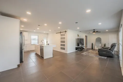 a large room with gym equipment and a view of living room