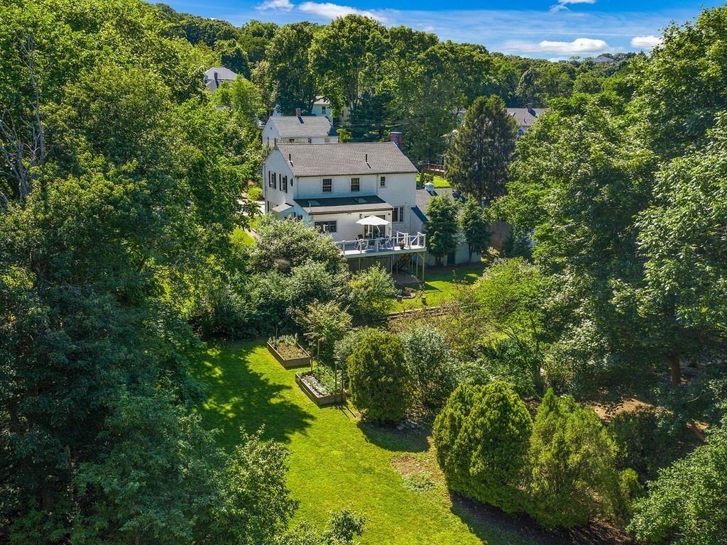 an aerial view of a house with a yard