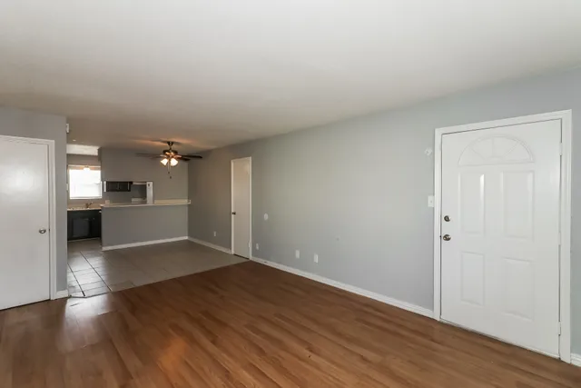 a view of a kitchen with wooden floor and a kitchen