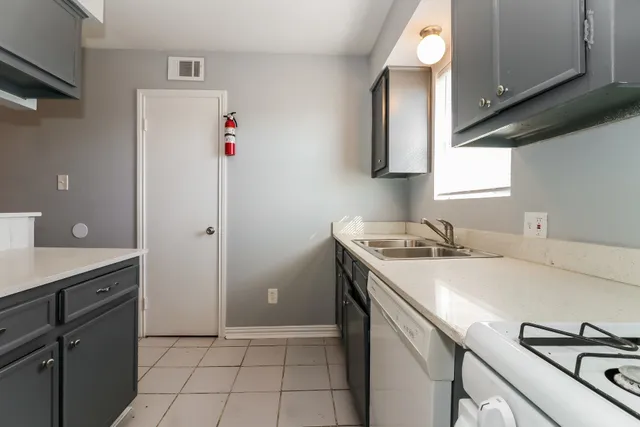 a kitchen with a sink cabinets and appliances