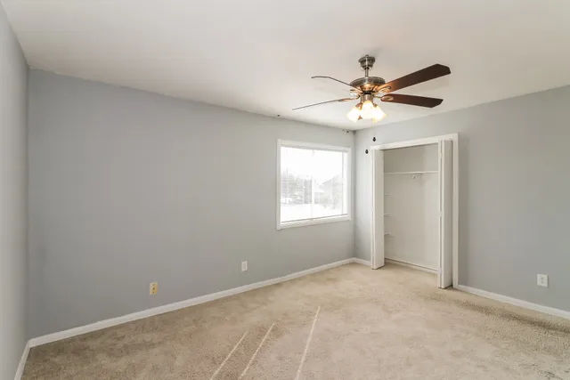a view of a room with a ceiling fan and a window
