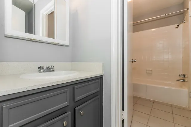 a bathroom with a granite countertop sink a toilet and shower