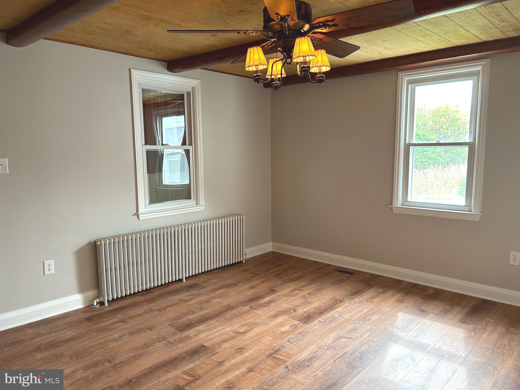 2244 Old Washington Road Westminster, MD 21157 - Photo 16 of 60 a view of an empty room with a window and wooden floor