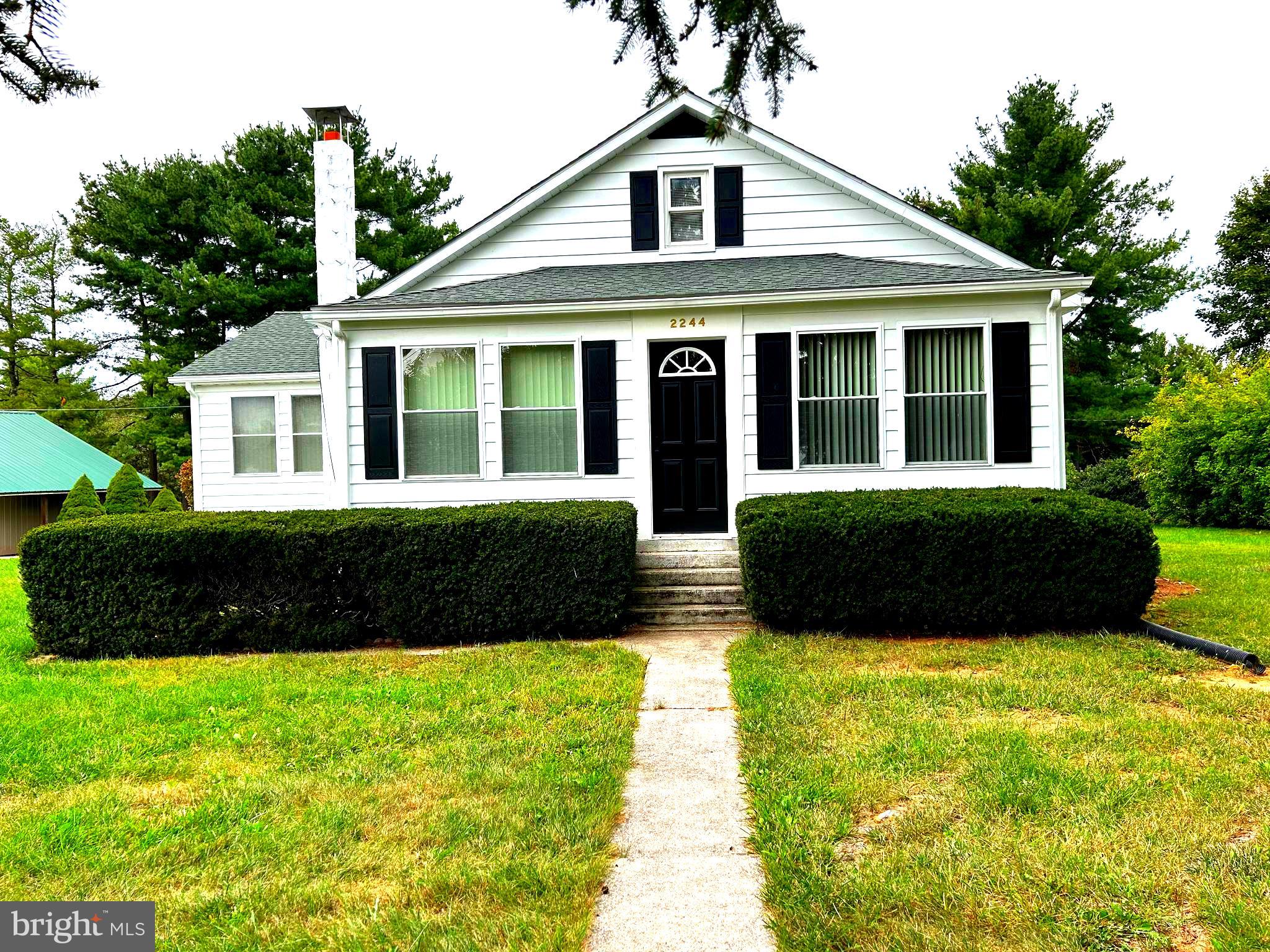 2244 Old Washington Road Westminster, MD 21157 - Photo 2 of 60 a front view of a house with a yard and potted plants