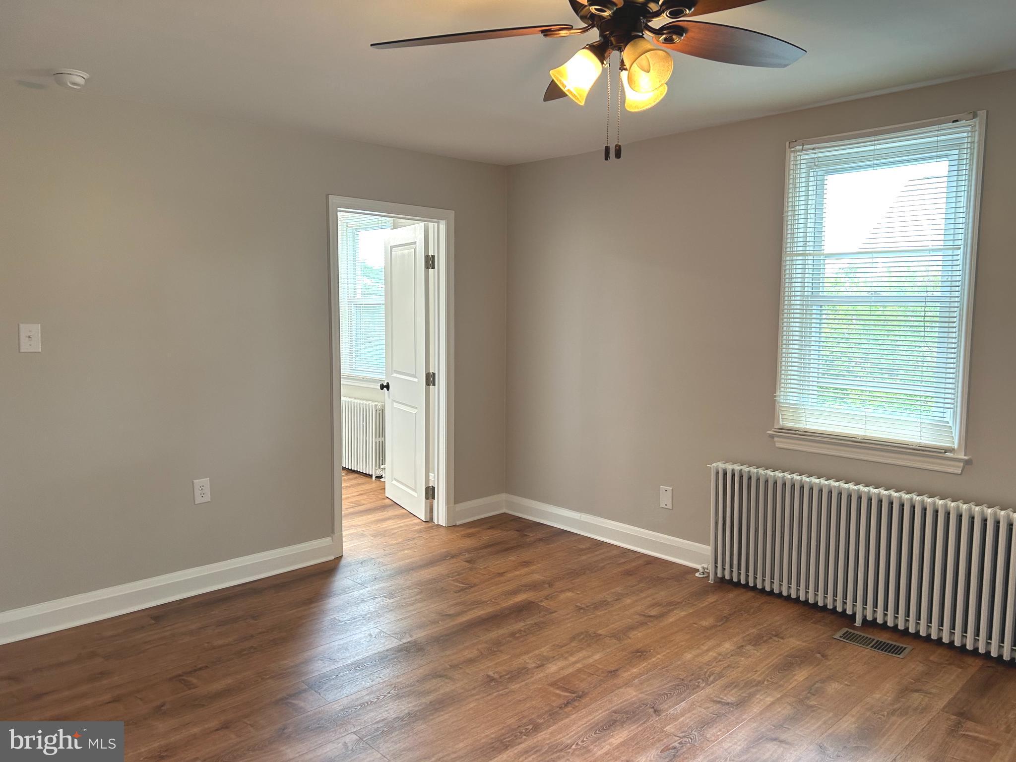 2244 Old Washington Road Westminster, MD 21157 - Photo 25 of 60 an empty room with wooden floor fan and windows