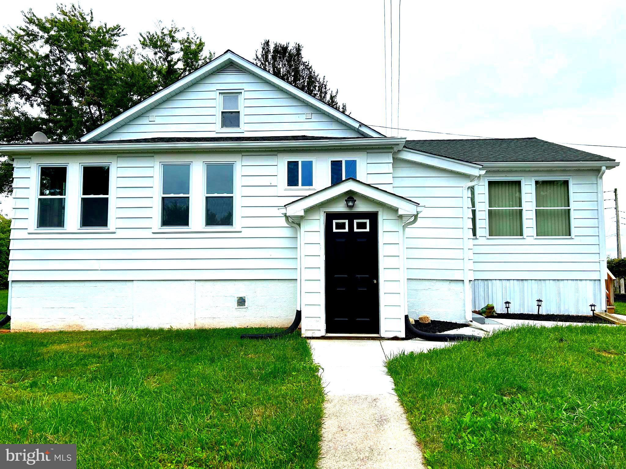 2244 Old Washington Road Westminster, MD 21157 - Photo 4 of 60 a front view of a house with a yard