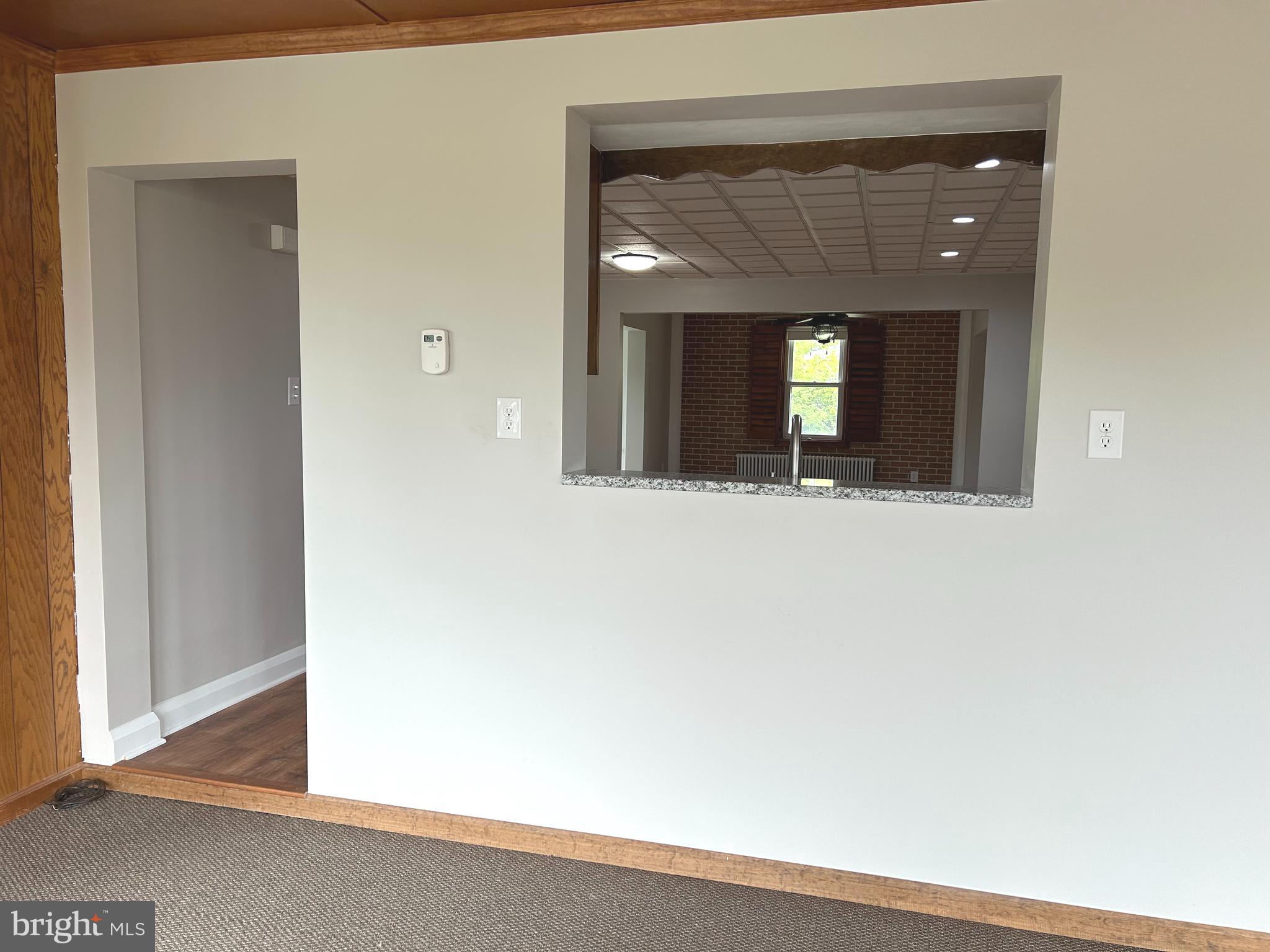 2244 Old Washington Road Westminster, MD 21157 - Photo 8 of 60 a view of a hallway with wooden floor and a large mirror