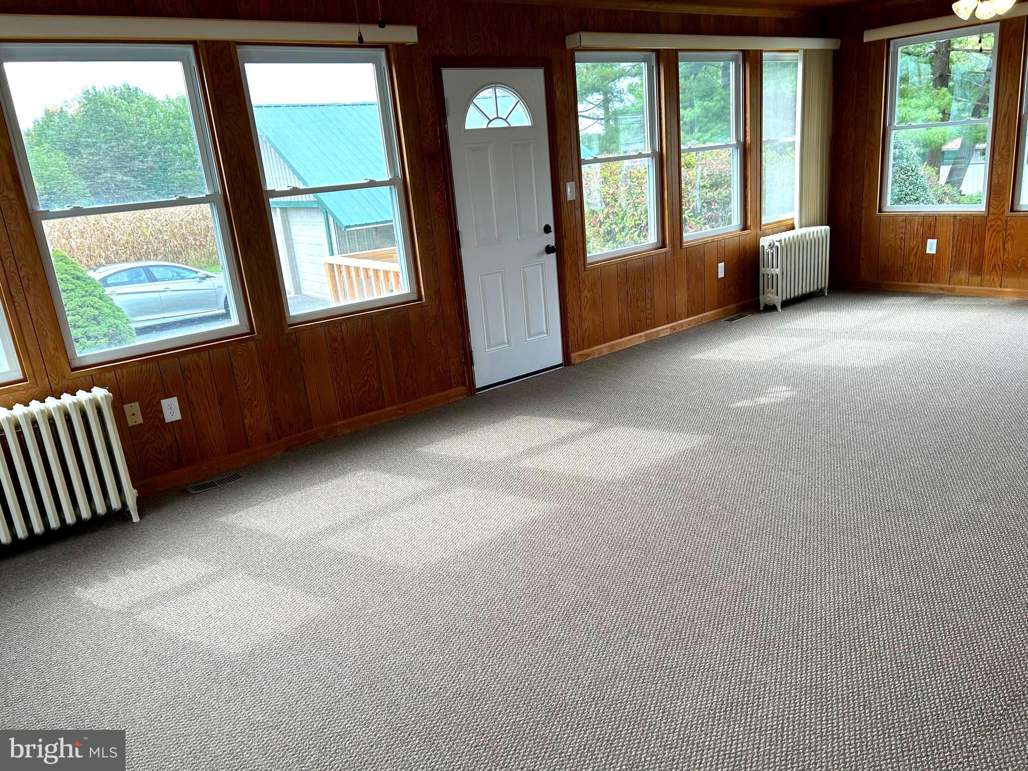 2244 Old Washington Road Westminster, MD 21157 - Photo 10 of 60 an empty room with large windows and couches
