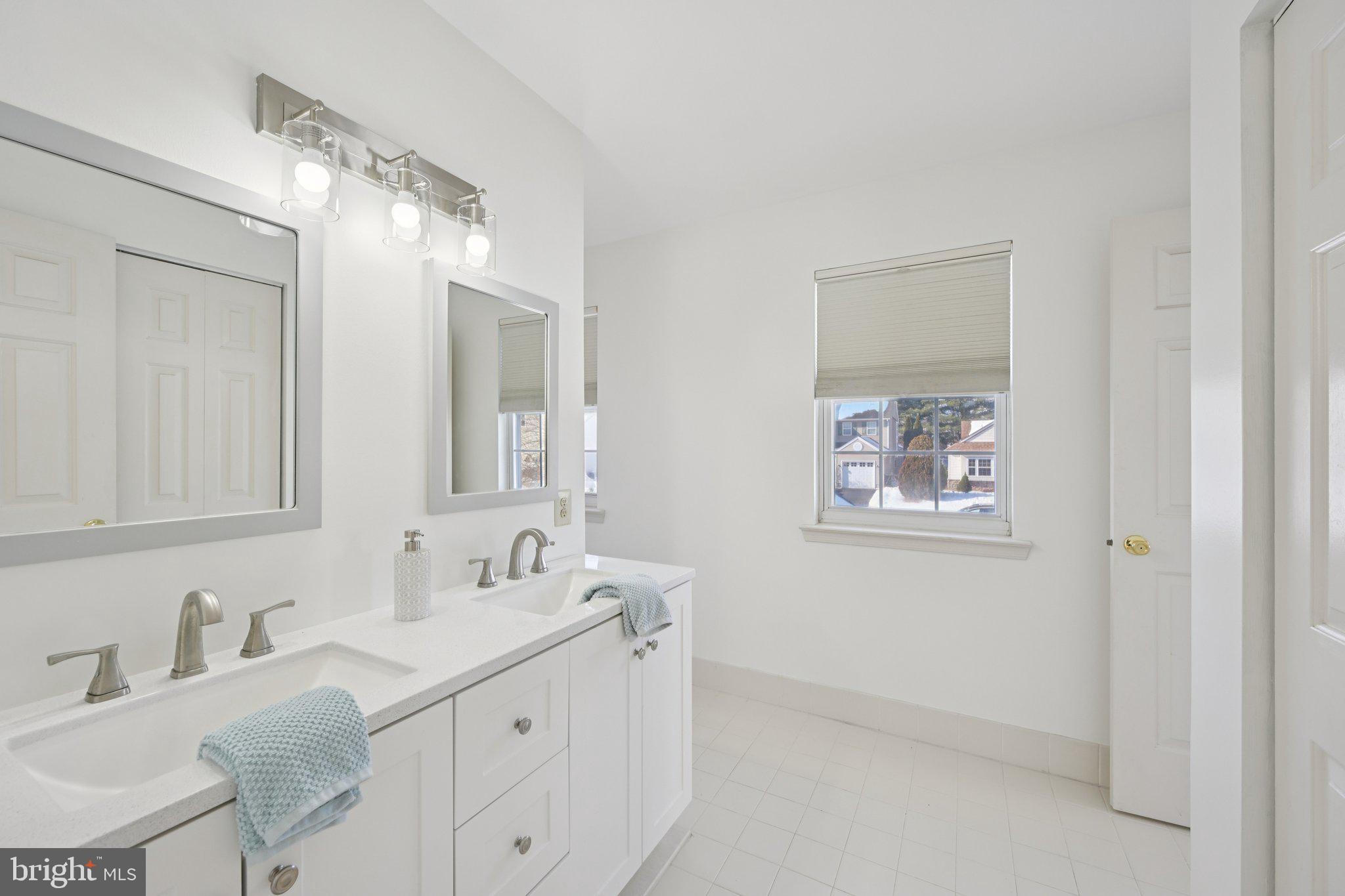 616 Stewart Road Collegeville, PA 19426 - Photo 25 of 56 a bathroom with 2 sink and a mirror