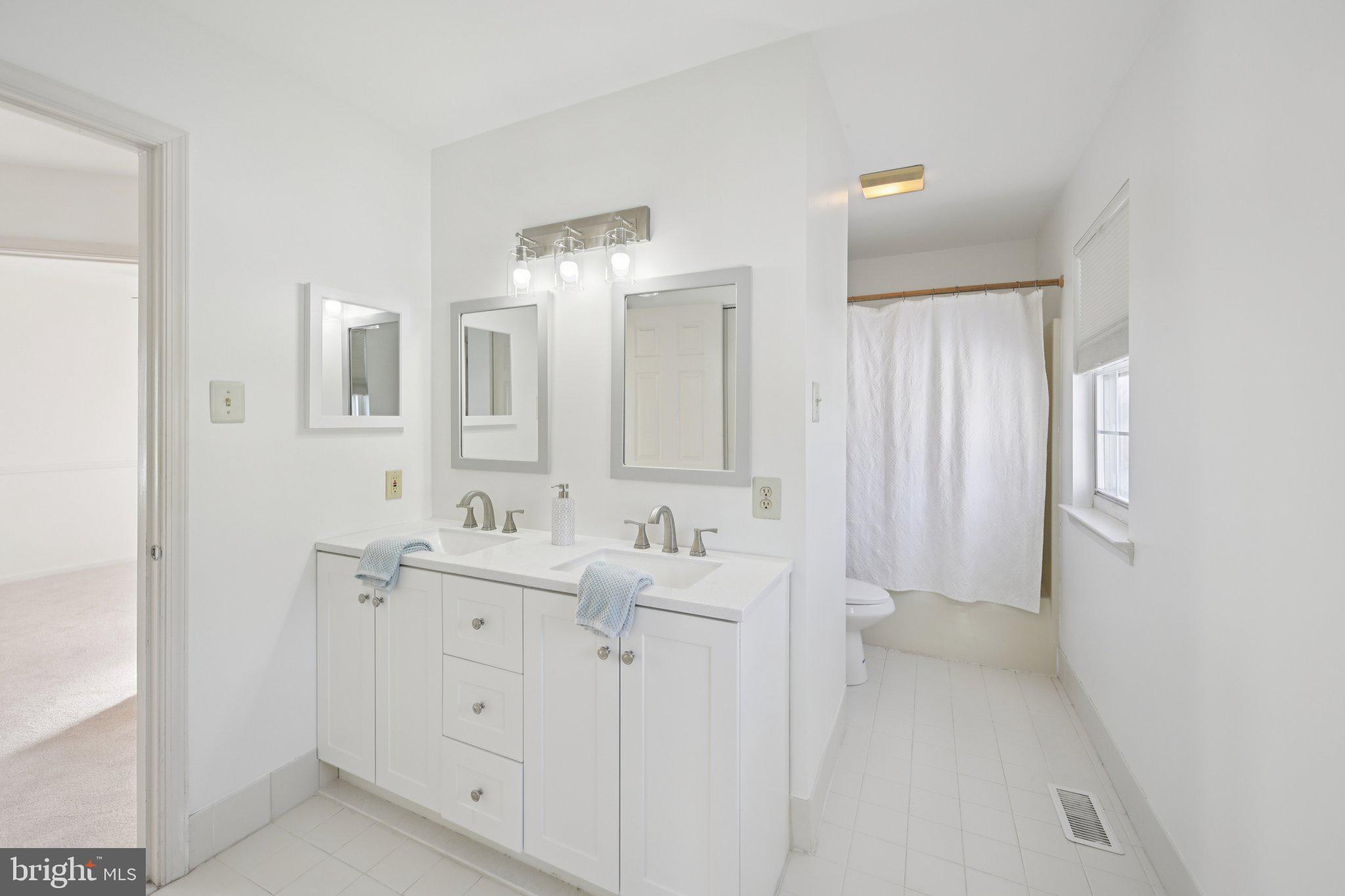 616 Stewart Road Collegeville, PA 19426 - Photo 26 of 56 a bathroom with a double vanity sink and mirror