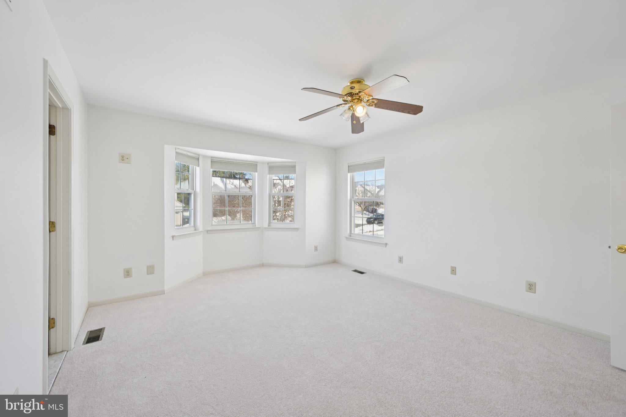 616 Stewart Road Collegeville, PA 19426 - Photo 27 of 56 an empty room with windows and chandelier fan