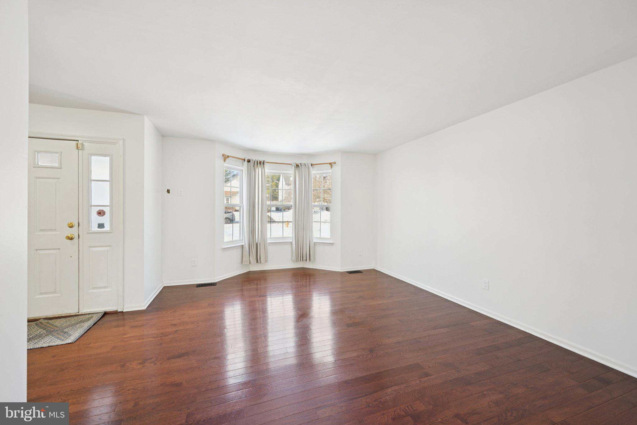 616 Stewart Road Collegeville, PA 19426 - Photo 10 of 56 an empty room with wooden floor and windows