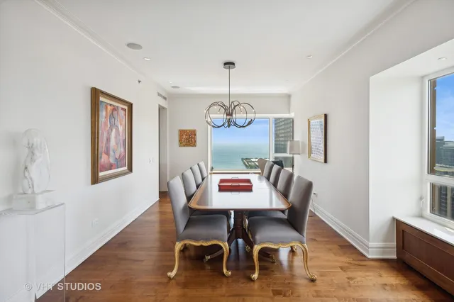a view of a dining room with furniture wooden floor and chandelier