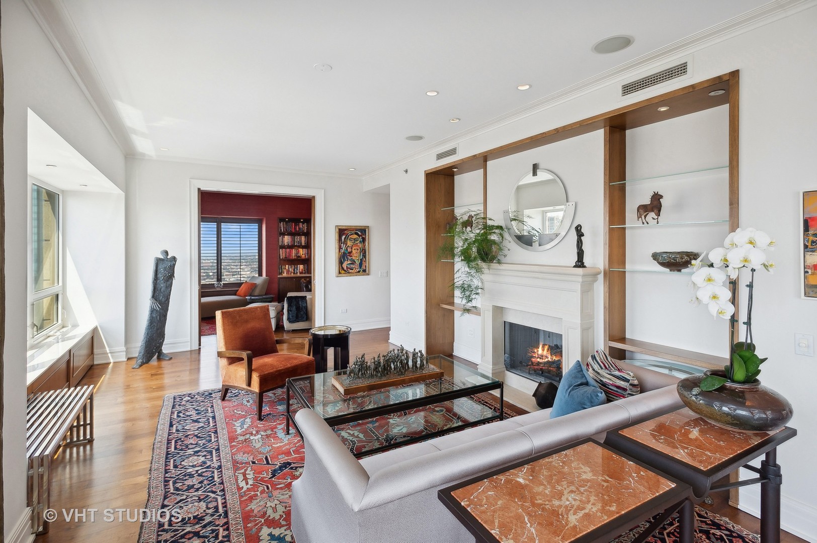 800 North Michigan Avenue, Unit 4702 Chicago, IL 60611 - Photo 17 of 31 a living room with furniture a fireplace and a table