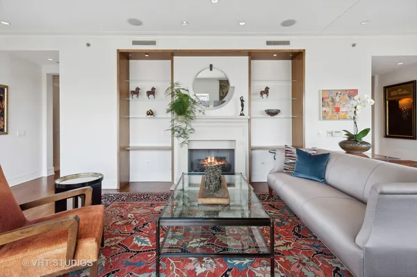 a living room with furniture a fireplace and a potted plant